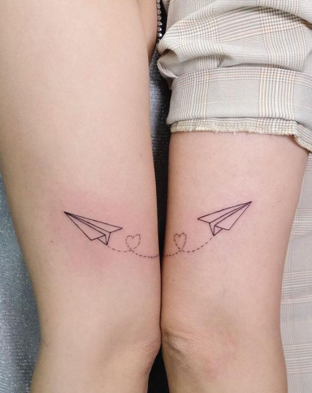 Word serendipity and paper airplane tattoo located on